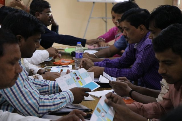 Teachers assembling the foldscope.